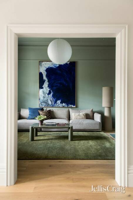 The formal living room has been painted sage green.