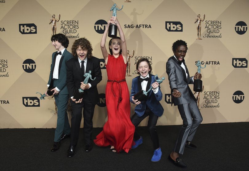 Finn Wolfhard, Gaten Matarazzo, Millie Bobby Brown, Noah Schnapp, and Caleb McLaughlin after winning outstanding performance by an ensemble in a drama series at the Screen Actors Awards in 2017, in Los Angeles.