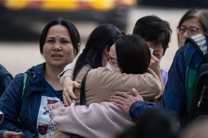 People with missing family members react after checking photographs of the deceased in Tai Po, Hong Kong, Nov. 27, 2025.