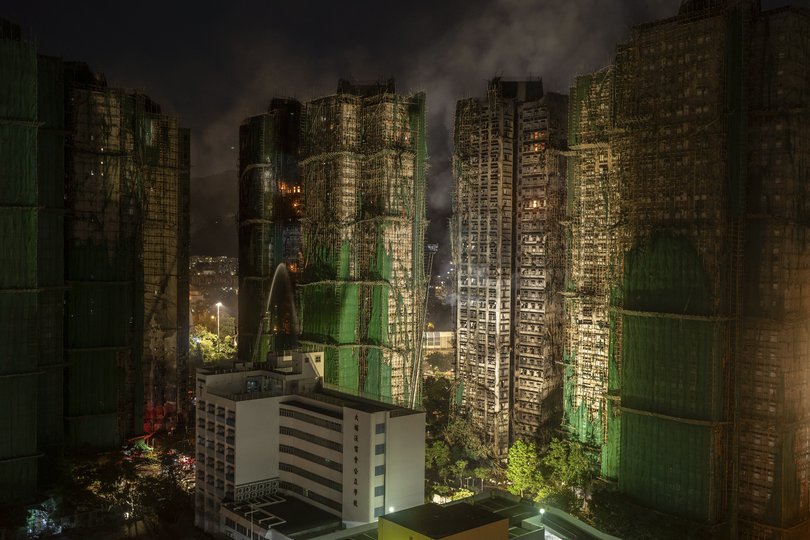 Fires continue to burn after dark in the Wang Fuk Court complex in the Tai Po district of Hong Kong, on Thursday, Nov. 27, 2025.
