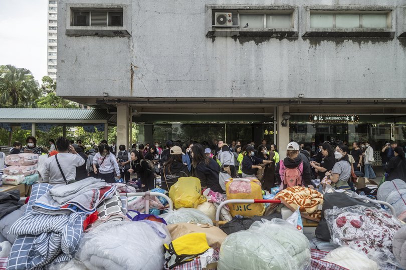 Volunteers sort donated items for residents displaced by the fire in the Wang Fuk Court complex in the Tai Po district of Hong Kong.