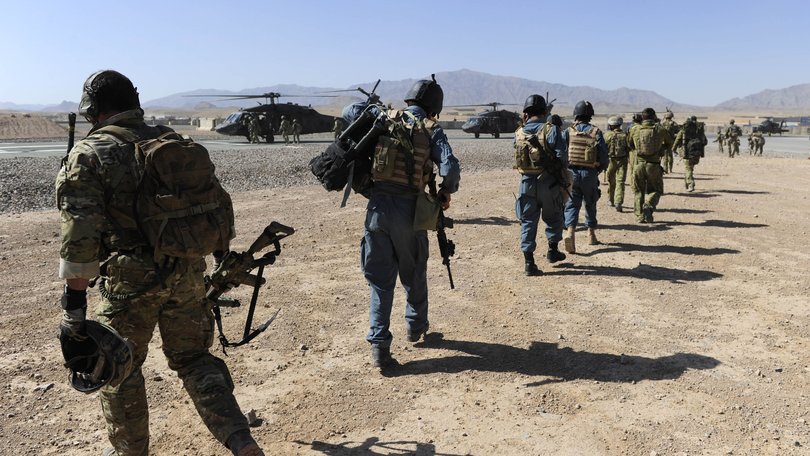 Afghan Officers from the Provincial Police Response Company and Australian Special Operations Task Group Soldiers move towards waiting UH-60 Blackhawk helicopters as part of the Shah Wali Kot Offensive.
