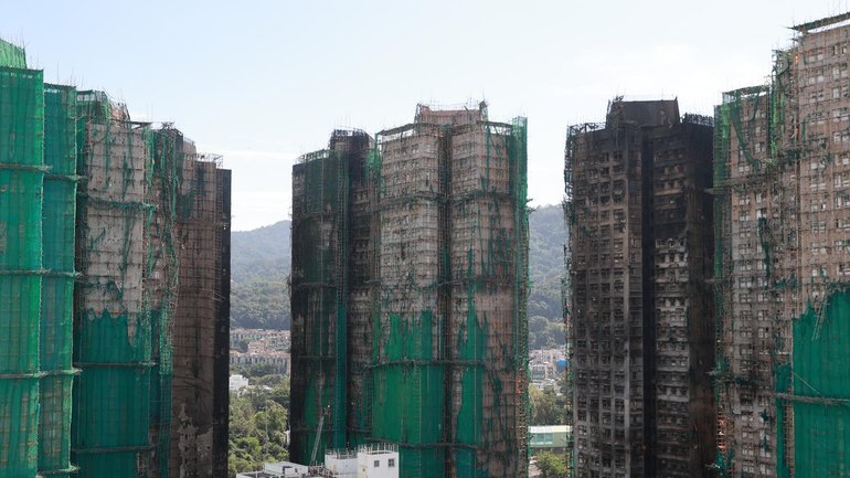 The Hong Kong towers that burned were wrapped in bamboo scaffolding and green mesh for renovations.