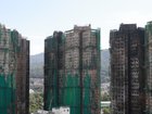 The Hong Kong towers that burned were wrapped in bamboo scaffolding and green mesh for renovations.