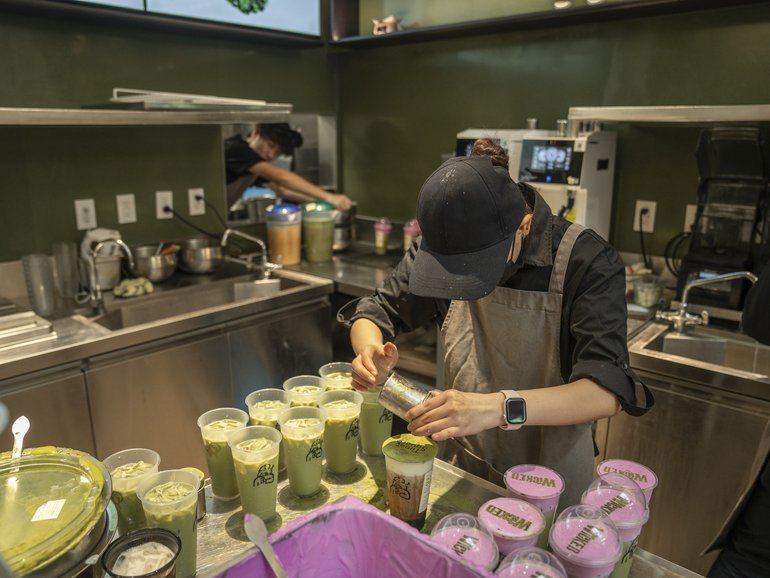 Staff members prepare drinks at HeyTea in Times Square in New York, October 16, 2025.