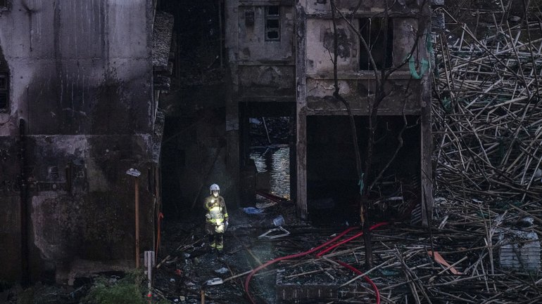 A rescue worker searches for casualties after the fire at the Wang Fuk Court residential towers in Hong Kong, Nov. 28, 2025. 