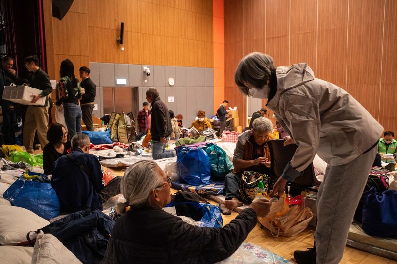 Elderly residents displaced by the fire at a shelter in Tai Po. At least eight workers died, and many of those who survived, after saving children and others in their care, are worried about losing their jobs and being forced to leave.