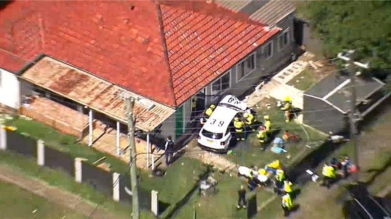 The police car can be seen with a crumpled bonnet.