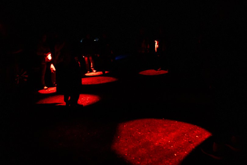 Aurora chasers in Keweenaw County, Michigan, navigate the woods at night using red flashlights, which help them preserve their night vision, September 13, 2025.