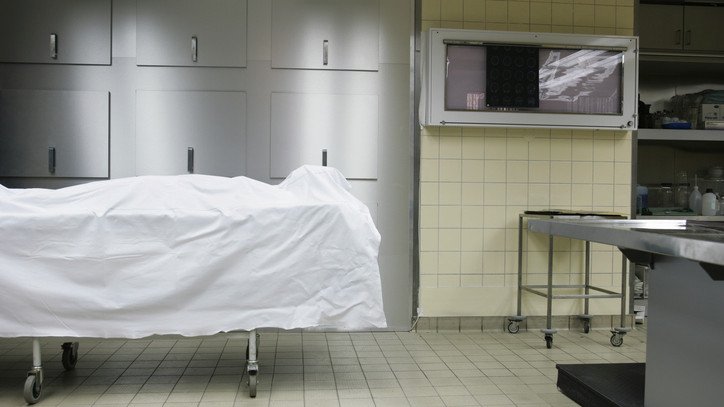 A woman who was mistakenly declared dead in her own kitchen was later found alive inside a hospital mortuary.