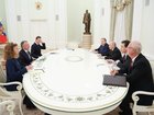 In this pool photograph distributed by the Russian state agency Sputnik, Russia's President Vladimir Putin, accompanied by Kremlin economic envoy Kirill Dmitriev and Kremlin aide Yuri Ushakov, meets with US special envoy Steve Witkoff and US President Donald Trump's son-in-law Jared Kushner at the Kremlin in Moscow on December 2, 2025.
