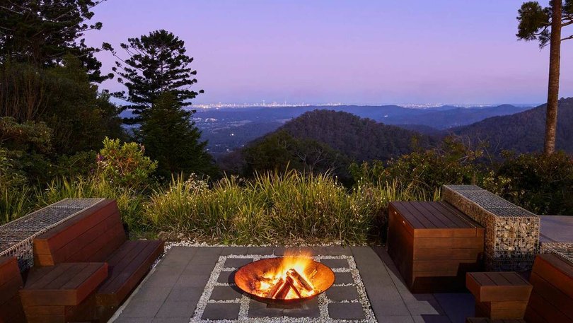 An intimate fire pit area looks out over the hinterland.