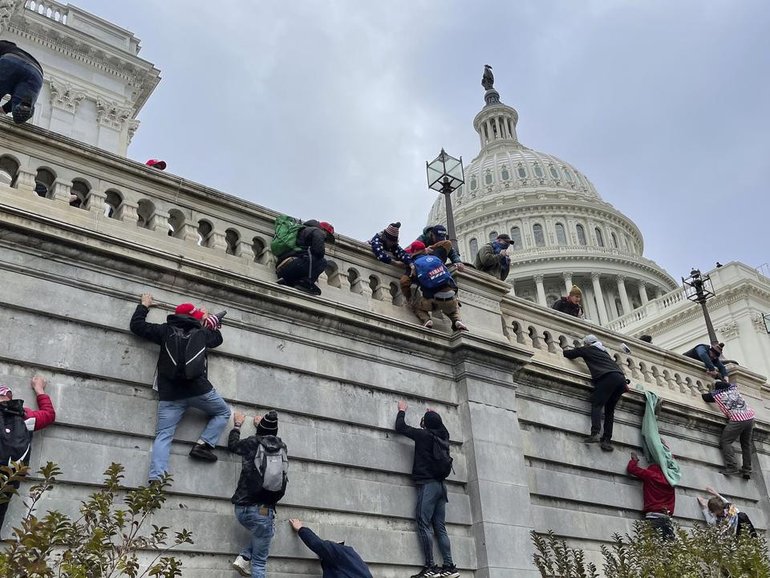 A man has been arrested on suspicion of planting pipe bombs in DC on the eve of the US riots. (AP PHOTO)