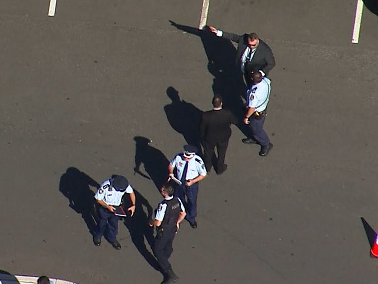 Panic has gripped Sydney’s southwest after gunmen opened fire in a Gregory Hills car park, sending workers and shoppers scrambling for cover.