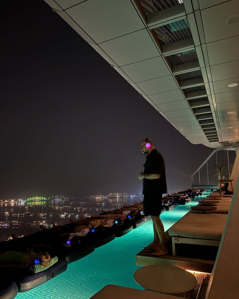 W Dubai – The Palm, a sleek five-star hotel shaped like a superyacht, regularly swaps pool parties for floating breathwork classes on padded li-los.