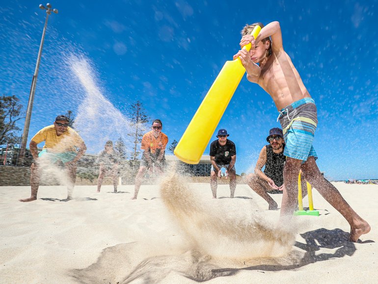 Australia Day 2022. City Beach. 13 year-old Oliver Clark plays beach cricket with (counter clockwise from batsman) Michael Snelling, Jack Gallagher, Travis Bestwick, Oscar Coyle, Elliott Comito Simon Santi