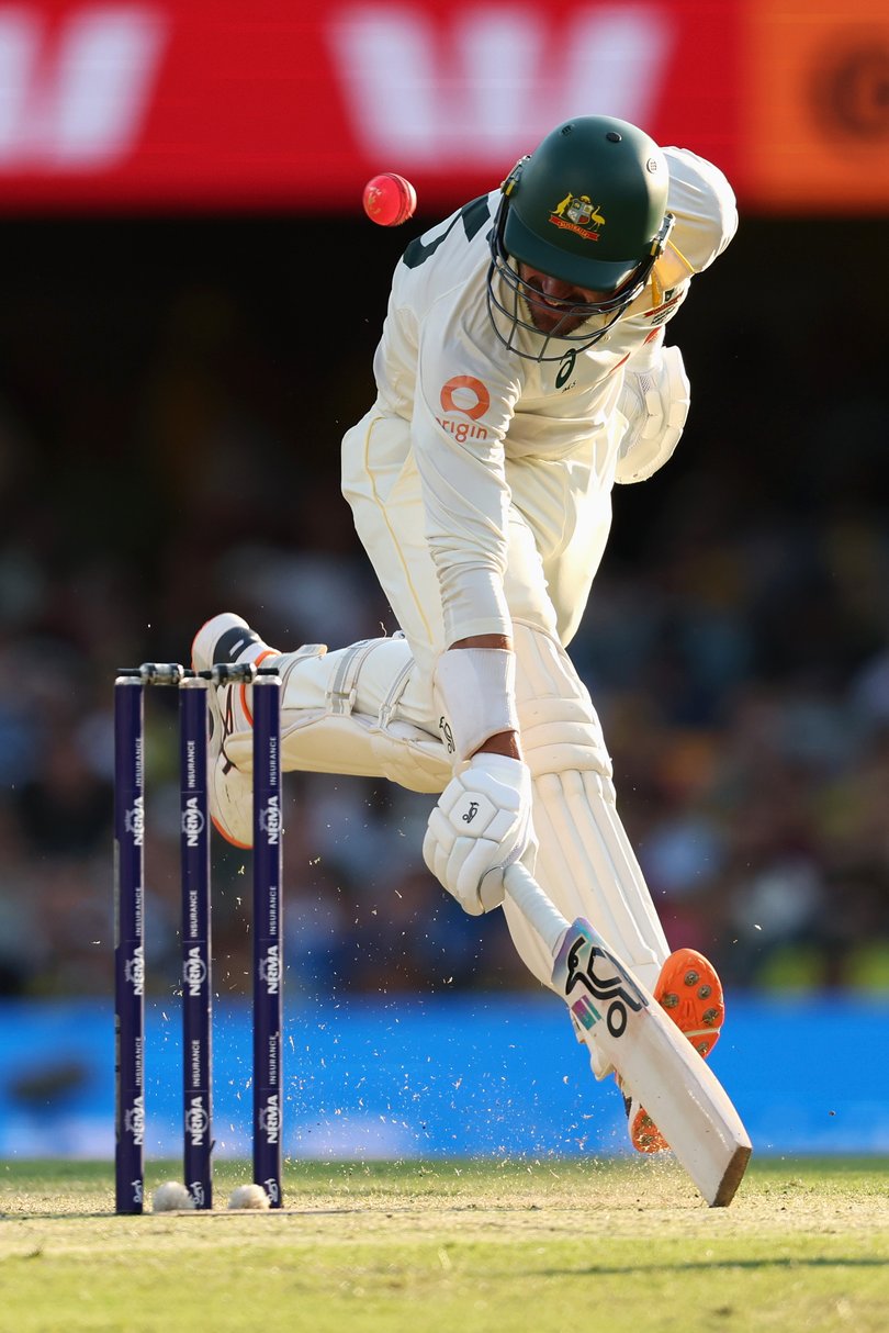 BRISBANE, AUSTRALIA - DECEMBER 06: Mitchell Starc of Australia is struck by the ball as he avoids a runout during day three of the Second 2025/26 Ashes Series Test Match between Australia and England at The Gabba on December 06, 2025 in Brisbane, Australia. (Photo by Cameron Spencer/Getty Images)