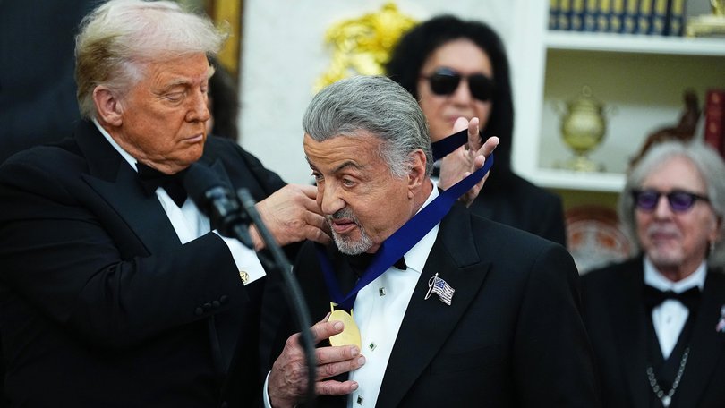 US President Donald Trump presents actor Sylvester Stallone with a medal as part of the 2025 Kennedy Center Honours.