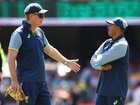 Australian coach Andrew McDonald speaks with Usman Khawaja at the Gabba on Sunday.