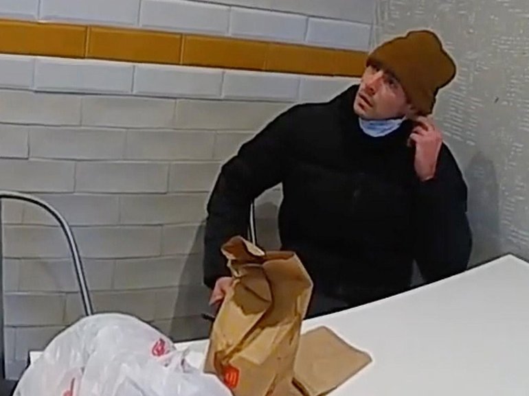 Luigi Mangione, a suspect in the fatal shooting of UnitedHealthcare CEO Brian Thompson, is confronted by police at a McDonald's.