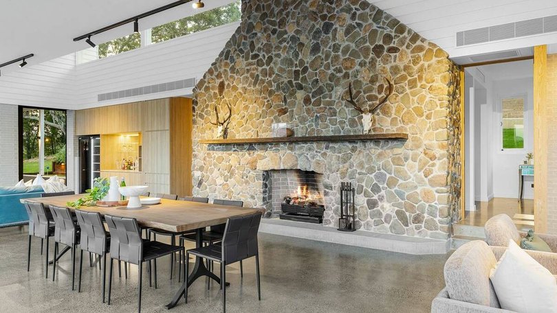 The living room centrepiece is a hand-crafted stone fireplace.