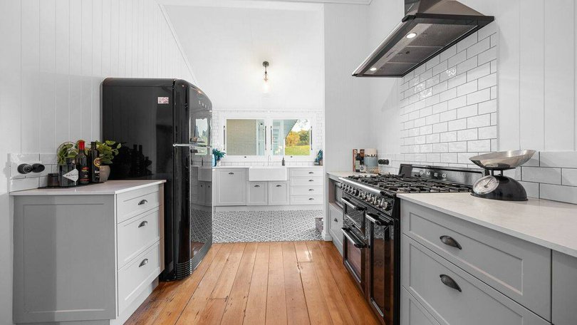 The modern kitchen features shaker-style cabinetry.