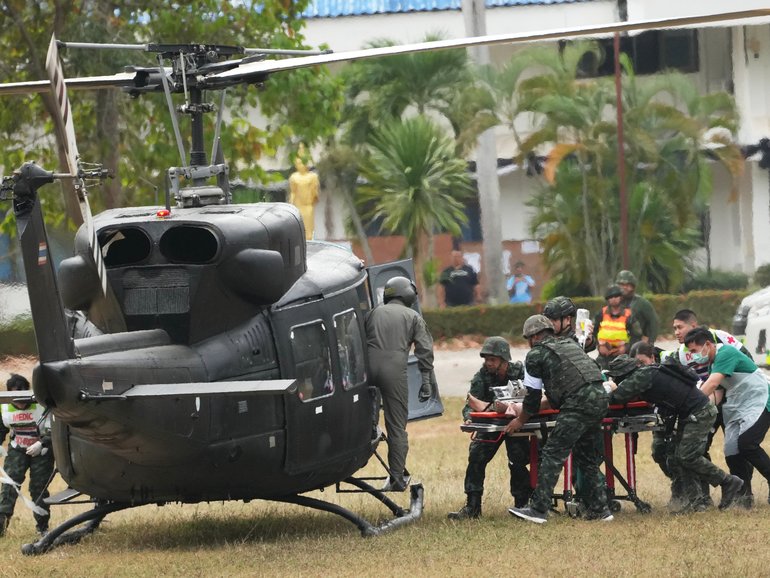 An wounded Thai soldier is carried to be transferred to a hospital, in Surin province, Thailand, following clashes between Thai and Cambodian soldiers. 