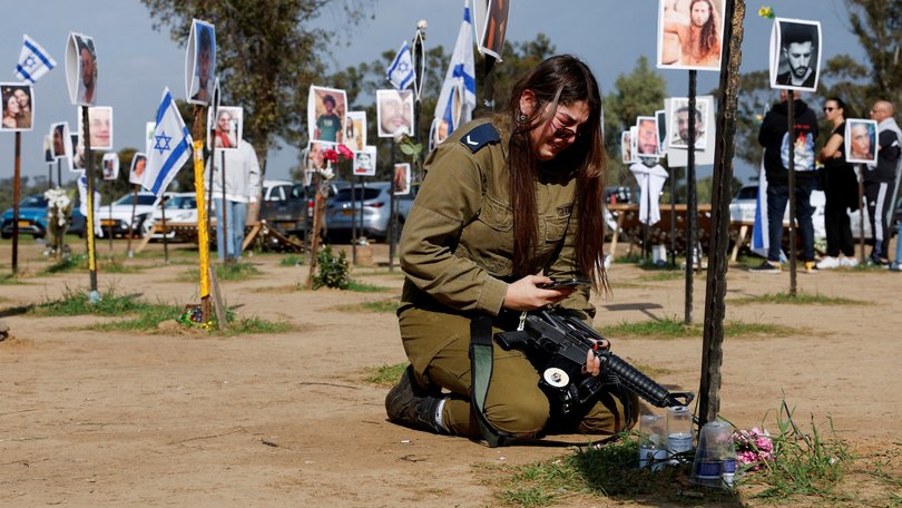 An Israeli soldier at a memorial of her family members Tair David and Hodaya David at the site of the Nova festival.
