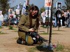 An Israeli soldier at a memorial of her family members Tair David and Hodaya David at the site of the Nova festival.