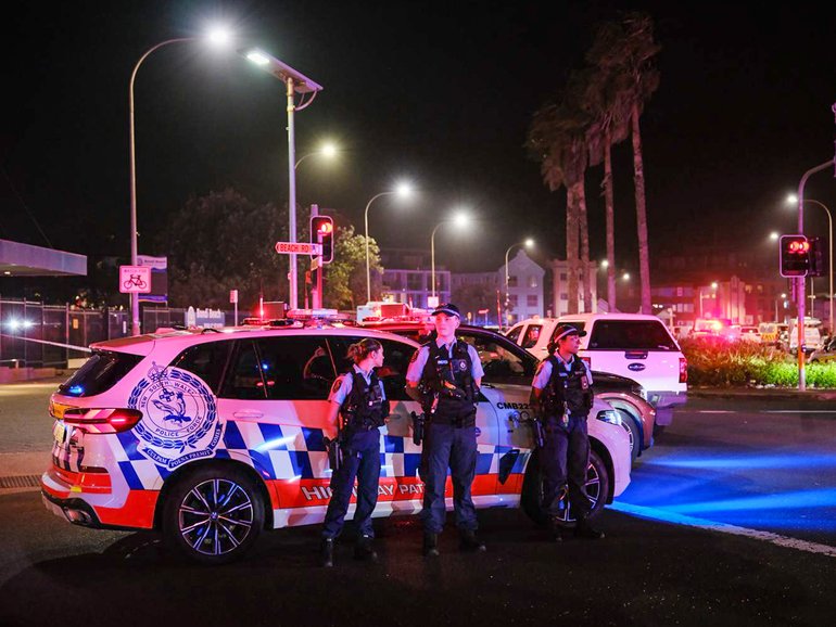 Police enforce a cordon at Bondi Beach after a mass shooting.