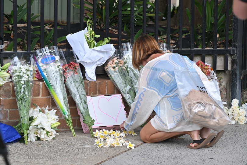Mourners placing flowers at a makeshift memorial at Bondi Beach in Sydney, Monday, December 15, 2025.