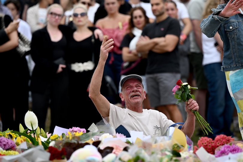 Mourners place flowers at a memorial at Bondi Beach in Sydney.