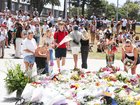People are seen placing flowers at a memorial at Bondi Beach Pavilion in Sydney after two gunmen opened fire on Bondi Beach. Photo: Gaye Gerard /NewsWire