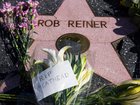 Flowers are seen placed on top of Rob Reiner's Hollywood Walk of Fame Star.