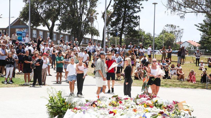 People are seen placing flowers at a memorial at Bondi Beach Pavilion in Sydney after two gunmen opened fire on Bondi Beach, late yesterday Sunday 14th December, killing 16 people in an attack designed to target the Jewish community. Photo: Gaye Gerard /NewsWire