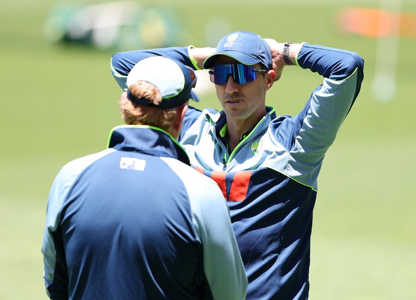 Pat Cummins talking with coach Andrew McDonald on Monday.