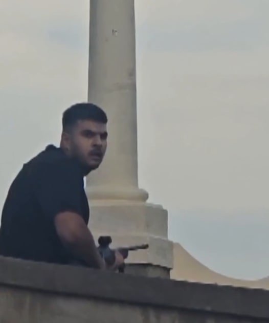 Bondi gunman Naveed Akram wa pictured wielding a firearm as his father Sajid put on his glasses during the terrifying attack.