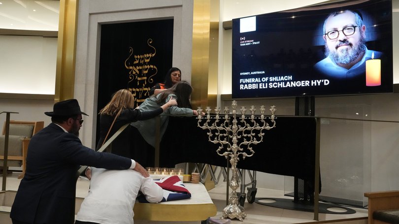 Family react at the coffin of Rabbi Eli Schlanger, a victim in the Bondi Beach mass shooting, during his funeral at a synagogue in Bondi.