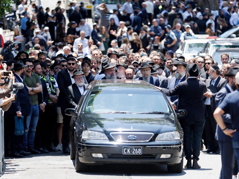 Mourners attend the funeral service for Rabbi Eli Schlanger at Chabad of Bondi.