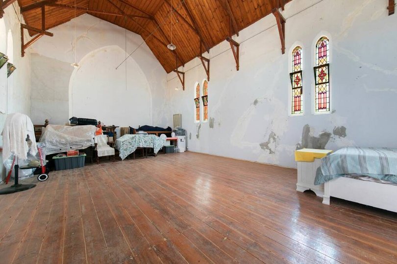 The church features timber floors and high ceilings.