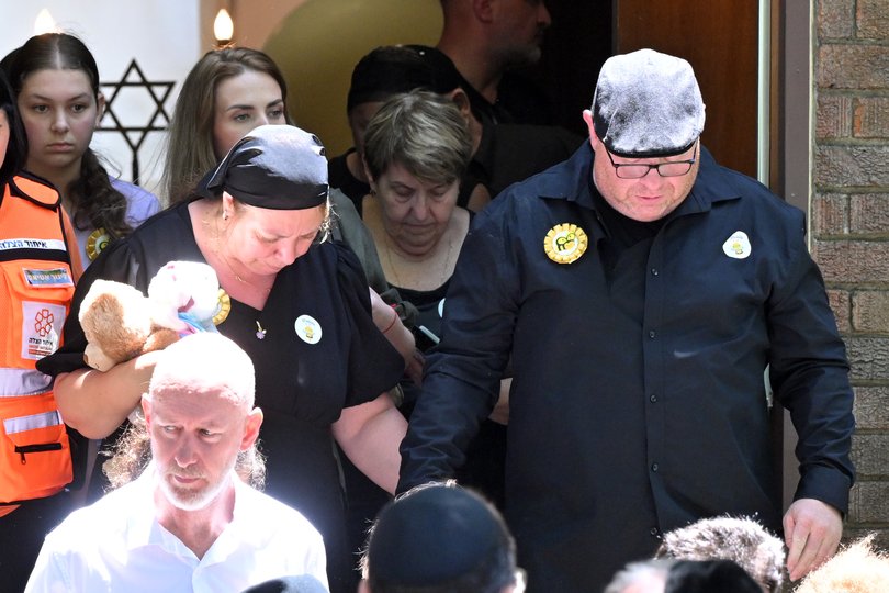 The mother and father Valentyna and Michael leave after the funeral for 10-year-old Matilda.