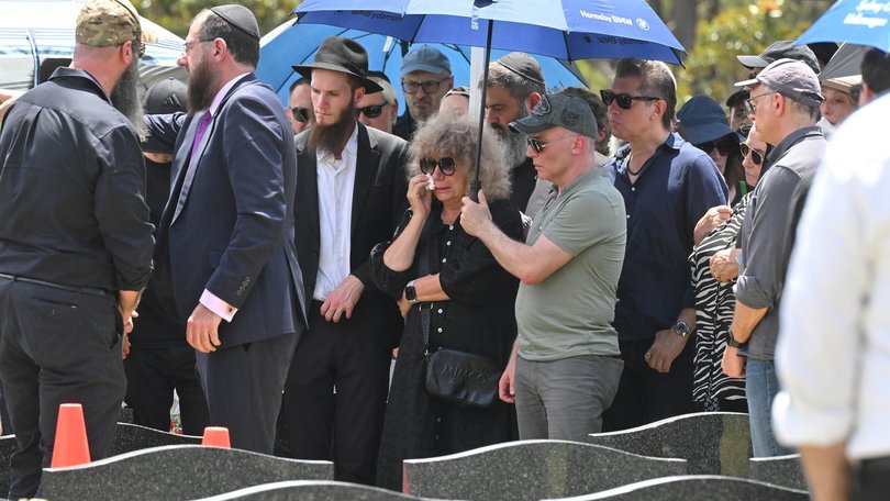 Mourners at the graveside service for Boris Tetleroyd.