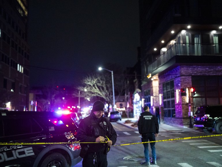 Hundreds of police officers swarmed the streets near Brown University late Saturday in search of a gunman who opened fire on students in a campus building. 