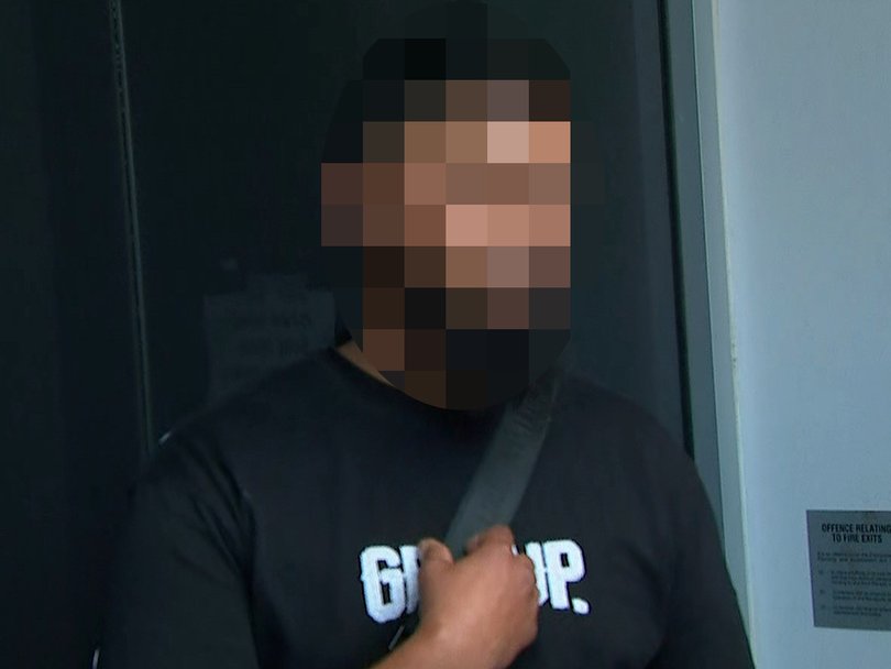 One of the seven men speaking to media.