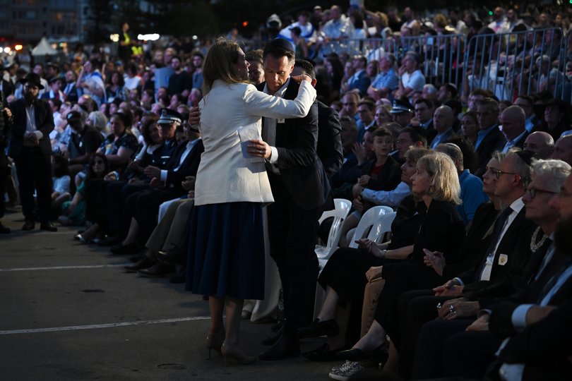 NSW Premier Chris Minns hugs NSW Opposition Leader Kellie Sloane during a National Day of Reflection vigil and commemoration for the victims and survivors of the Bondi Massacre.
