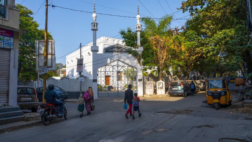 People walk on a street in Toli Chowki, an area of the southern Indian city of Hyderabad with many Muslim residents, Dec. 19, 2025. A neighborhood in India fears being blamed for a distant atrocity; the attacker killed at last week’s Hanukkah celebration in Australia came from a Muslim area whose residents have long gone abroad to seek better lives. (Saumya Khandelwal/The New York Times)