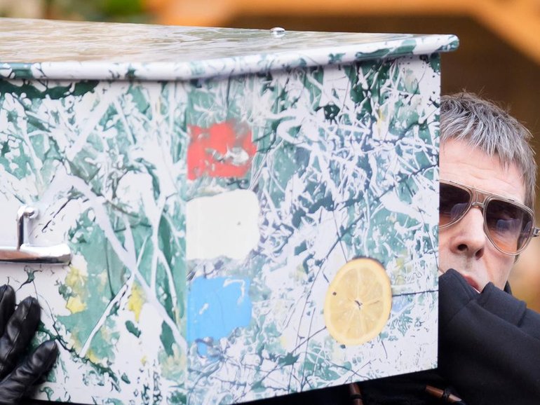 Liam Gallagher helped carry the coffin of Stone Roses and Primal Scream bass player Gary Mounfield. (AP PHOTO)