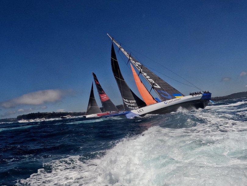 SYDNEY, AUSTRALIA - DECEMBER 26: Law Connect and Wild Oats (L), lead the fleet out of the heads during the 2022 Sydney to Hobart on Sydney Harbour, on December 26, 2022 in Sydney, Australia. (Photo by Mark Evans/Getty Images)