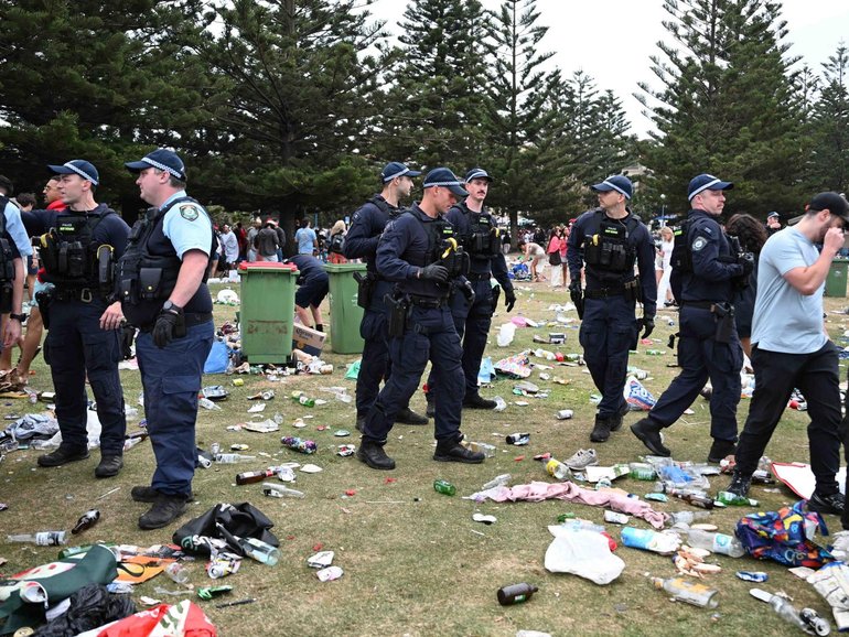 Police cleared the scene as revellers left large amounts of rubbish in their wake. NewsWire / Monique Harmer