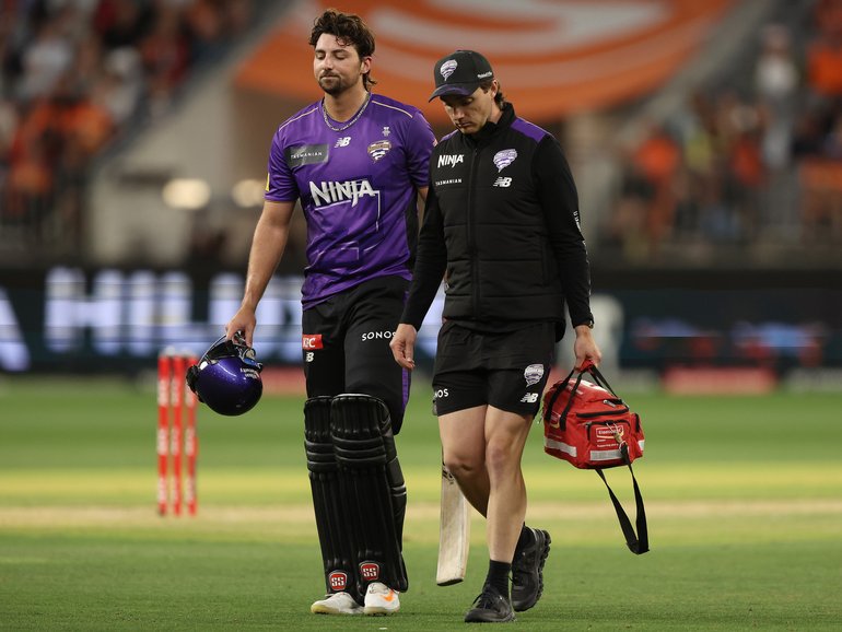 Tim David of the Hurricanes leaves the field injured.